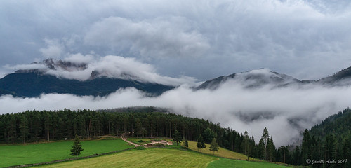 2019 dolomites europe italy latemar wieserhof atmospheric cloud cloudy farmland moody mountainrange pano panorama rain rainclouds trees novaponente