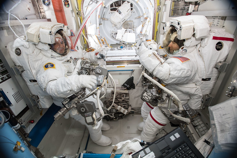 NASA astronauts Andrew Morgan and Christina Koch are suited up in U.S. spacesuits