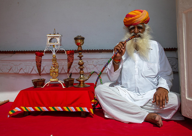 Portrait of a rajasthani guard smoking in the fort, Rajasthan, Jodhpur, India
