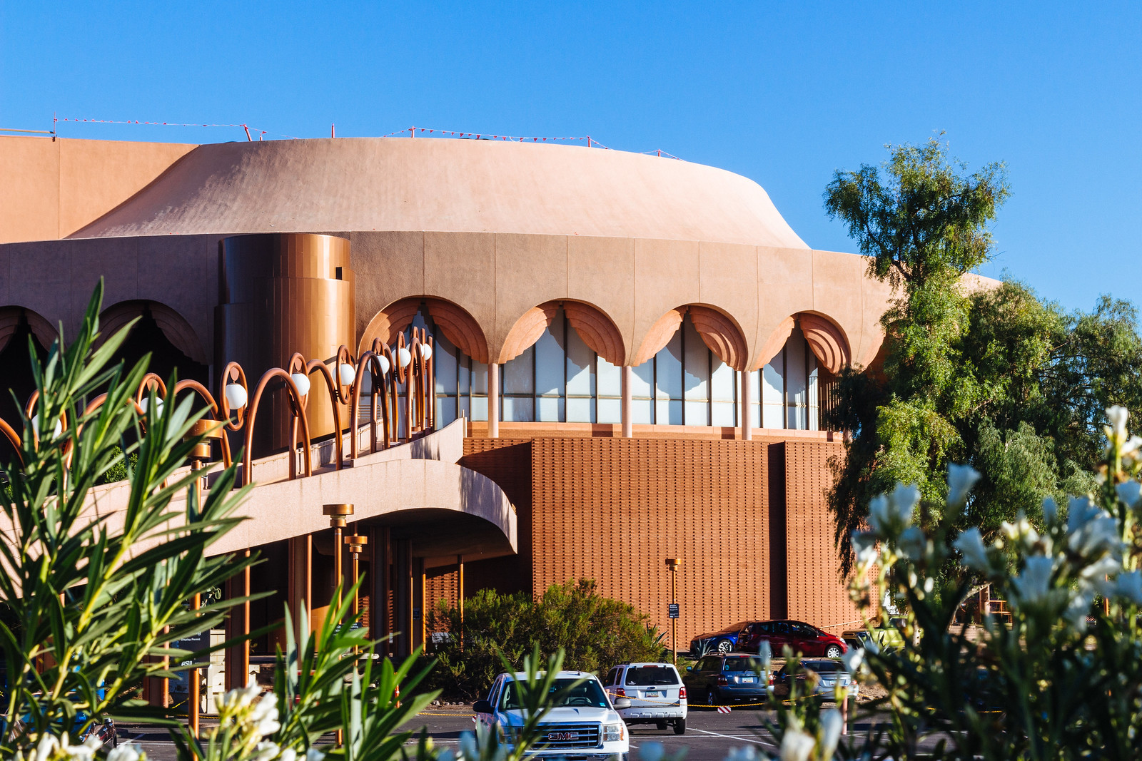 Rusty orange circular building with arcades that look like window drapes on ASU in Tempe, Arizona