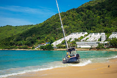 Disaster at sea. The wreck of a sailing yacht. The yacht was dropped from the anchor and thrown to the beach. Waves break the hull and fill it with water. Nai Harn Beach, Phuket, Thailand
