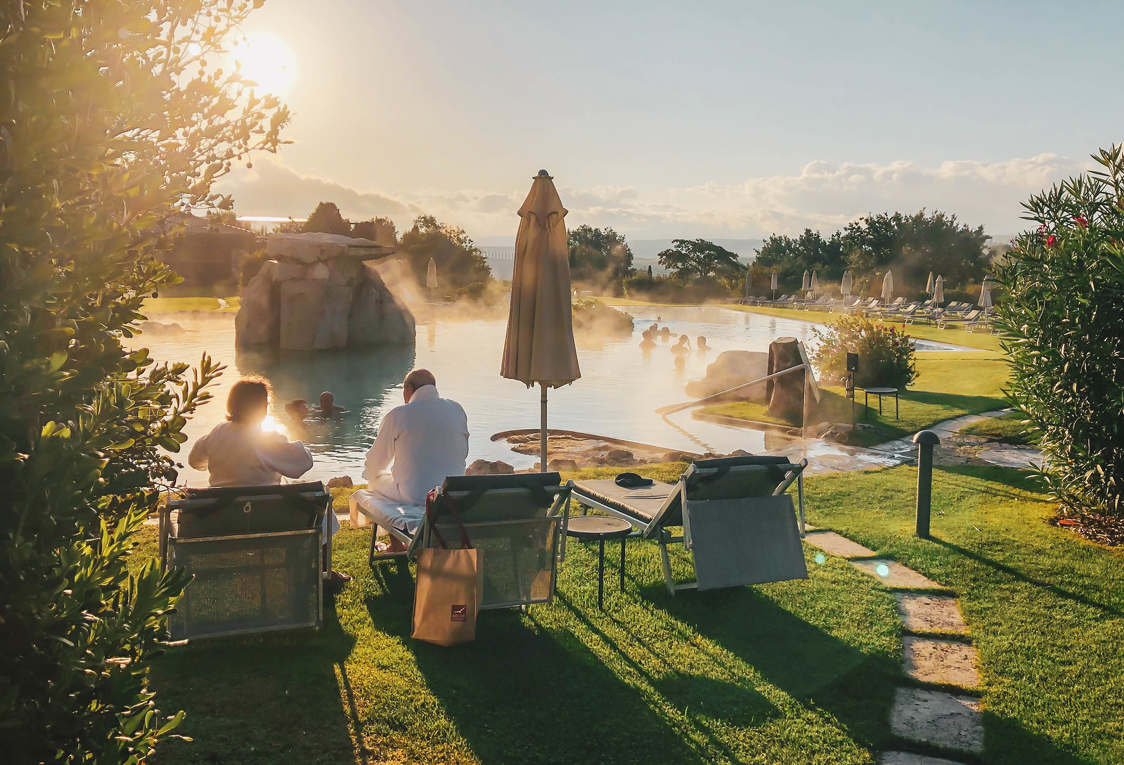 Two people relaxing by the thermal waters at the Hotel Adler Thermae Spa and Relax Resort, Italy