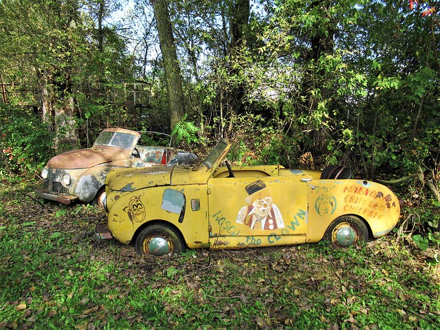 Yellow clown car, other vintage car, Dr. Evermor's Sculpture Park, Bluffview, Wisconsin