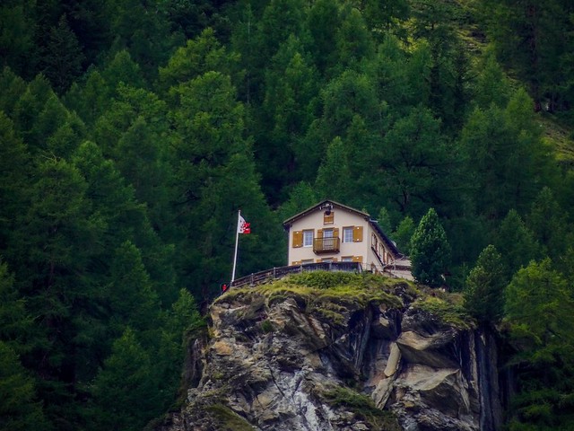 A house on top of a rock. High up and around nature.