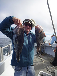 Richard Gunion holds up a nice pair of sea bass.