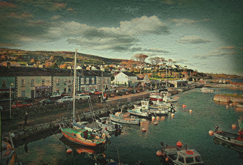 carnloughharbour countyantrim northernireland sea water boats fishing trips boating sailing town village shops road cars hills cliffs trees clouds sky outdoor colour texture art artwork