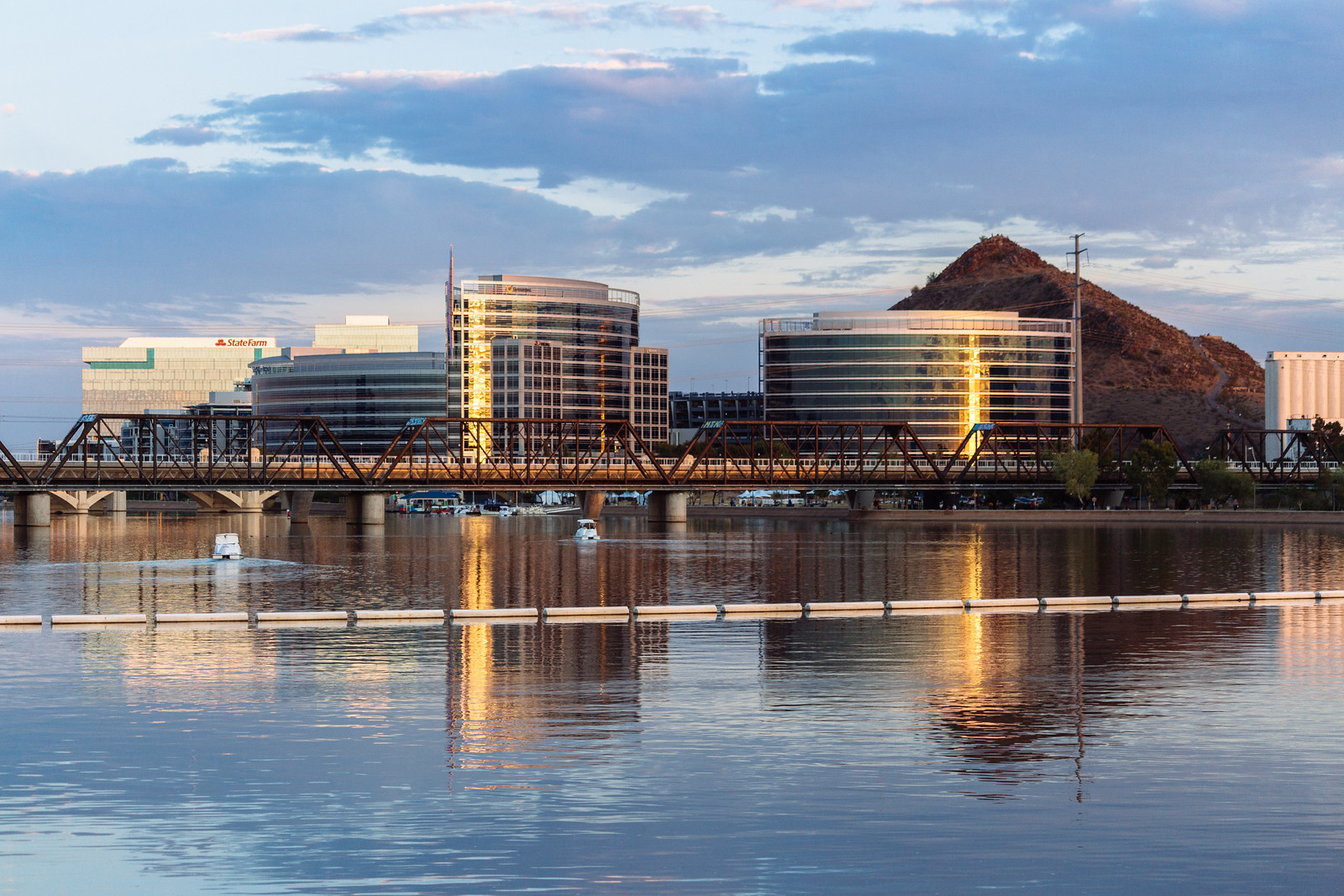 Office buildings and a mountain reflecting on a lake at sunset in Tempe, Arizona