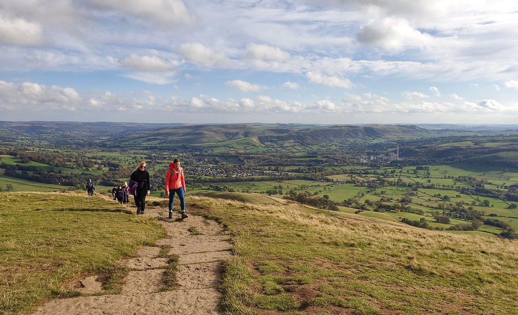 Hikers reach a hilltop in the Peak District