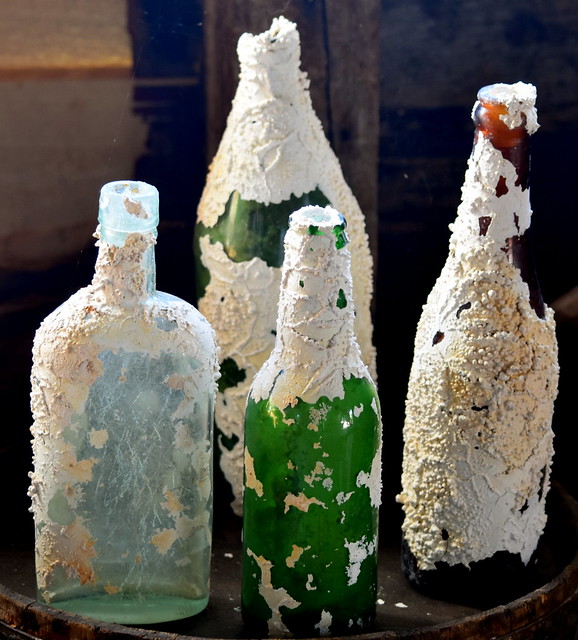 NICELY ENCRUSTED OLD BOTTLES WITH A COLORFUL PAST.   AGED FROM WITH THE HELP OF THE ATLANTIC OCEAN.  NEWFOUNDLAND.