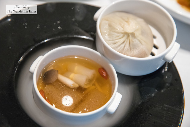 Two-tiered service bowls of soup dumpling (the one you drink with a straw) and chicken, mushroom and goji berry soup