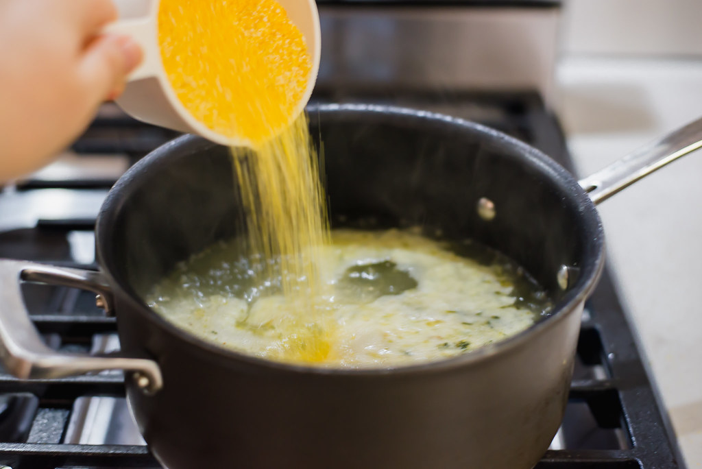 To make parmesan polenta, boil 4 cups of stock and then pour in cornmeal while whisking.