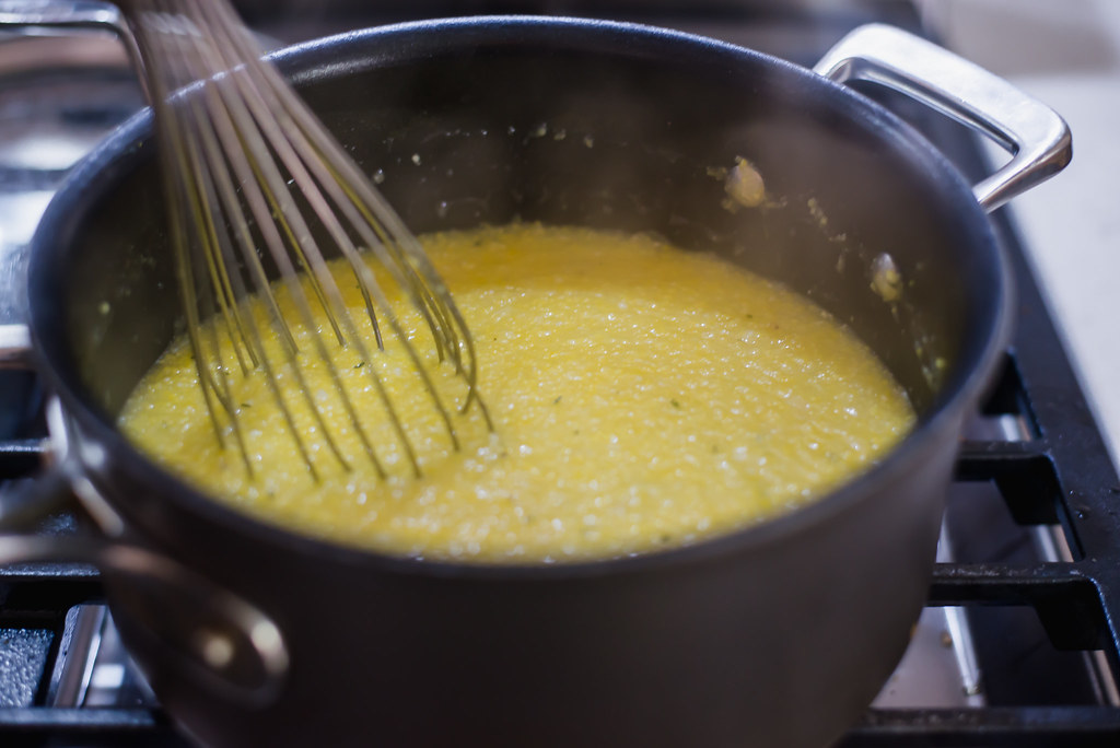 Whisk the cornmeal with the stock until polenta thickens. Then stir in grated parmesan cheese.
