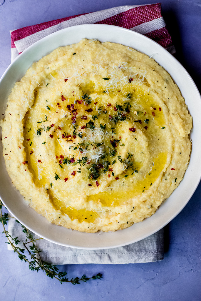 A simple and impressive side dish. Creamy parmesan polenta is tossed with fresh thyme and grated Parmesan cheese making it perfectly savory.