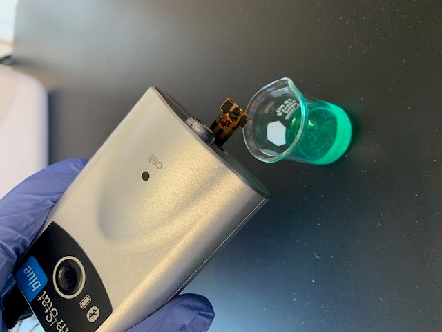A nanosensor connected to a portable potentiostat to monitor pesticides in a sample fluid