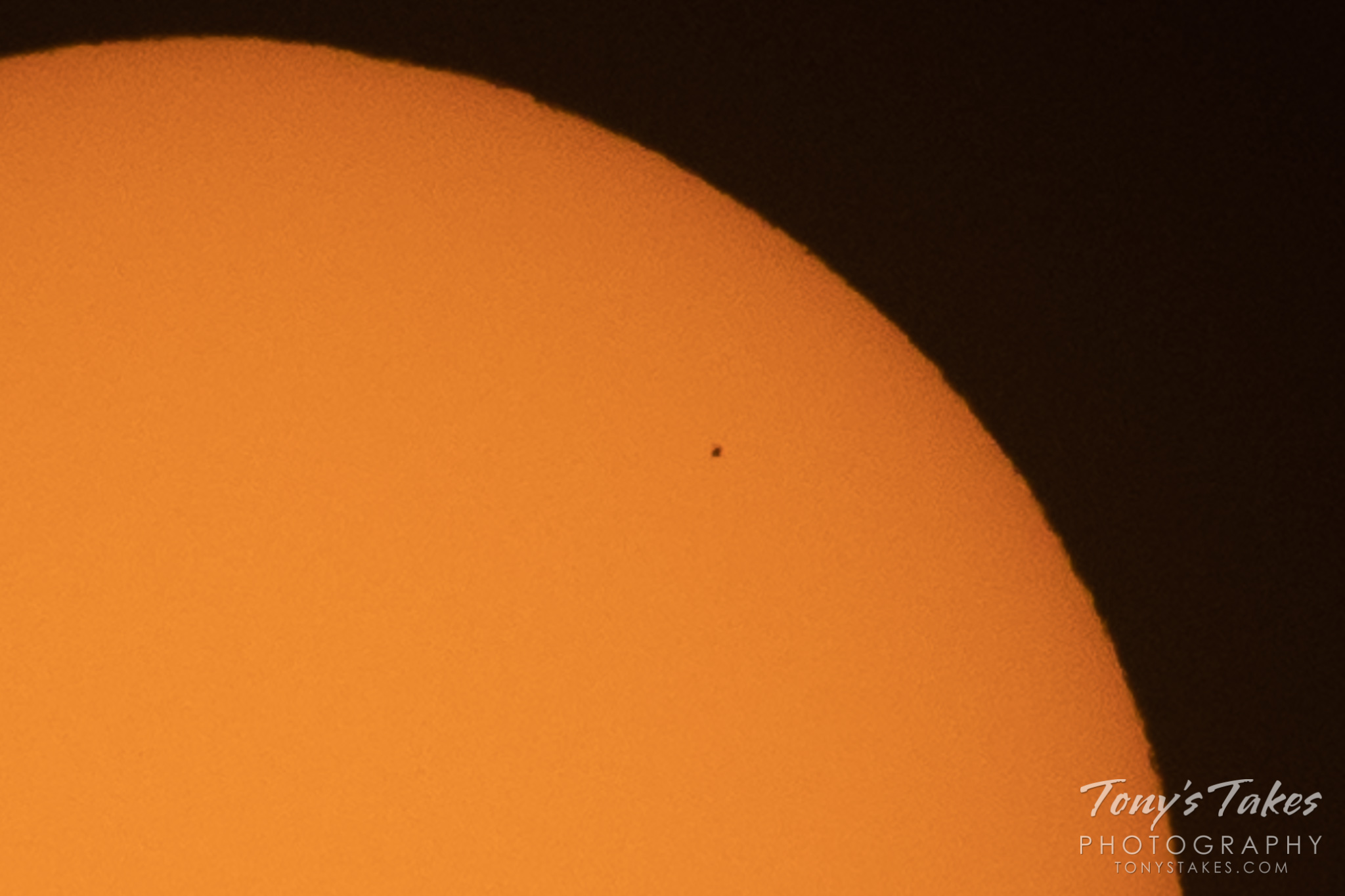 The planet Mercury transits in front of the sun. (© Tony’s Takes)