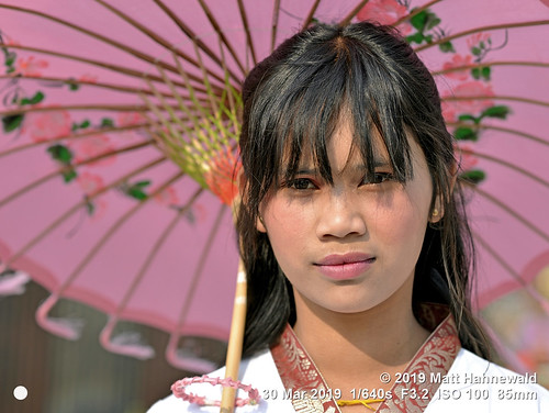 matthahnewaldphotography facingtheworld qualityphoto head face eyes bangs fringe mouth lips lipstick expression consensual conceptual travel tourism grace beauty style oriental traditional cultural folklore shanstate myanmar burma burmese asia asian person one female young woman women backdrop primelens nikond610 nikkorafs85mmf18g 85mm street portrait closeup headshot fullfaceview outdoor sunlight colour posingcamera feminine beautiful attractive sensual pretty lovely parasol umbrella oilpaperumbrella holding girl kalaw pink confident clarity lookingatcamera