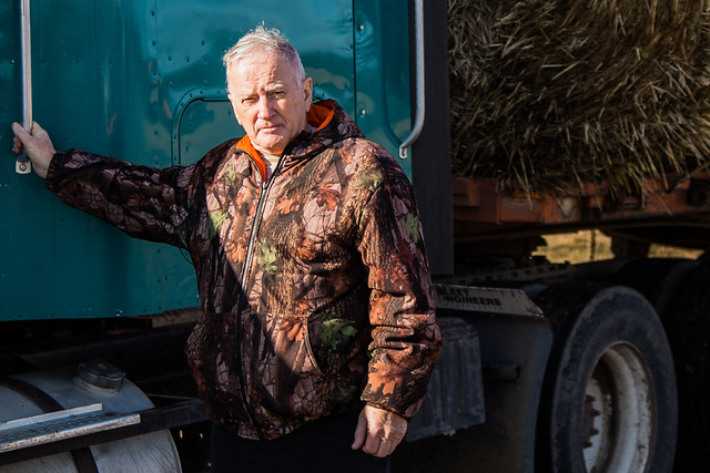 North Dakota Rural Development Associate Director Myron Lepp standing next to a hay trailer