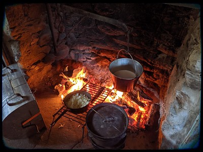 Multiple courses of a meal cook inside the open hearth. 
