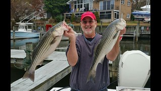 Photo of man holding striped bass 