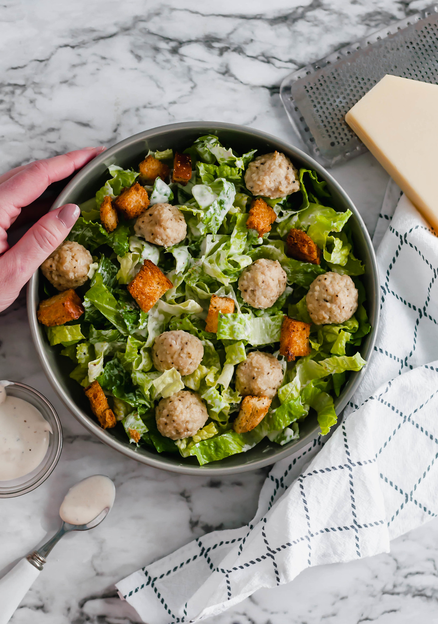 Salad Meal Prep is the perfect way to start out your New Year healthy. 45 minutes of prep results in a weeks worth of healthy and delicious lunches. Caesar dressing, homemade croutons and mini chicken meatballs add lots of flavor to the mix.