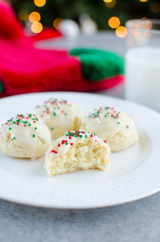 Italian Sugar Cookies - soft lemon sugar cookies with a lemony glaze and sprinkles on top! These are a Christmas favorite and are so cute in cookie tins. 