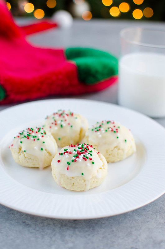 Italian Sugar Cookies - soft lemon sugar cookies with a lemony glaze and sprinkles on top! These are a Christmas favorite and are so cute in cookie tins. 
