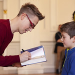 Tom Fletcher signs book for young fan: © Robin Mair | 