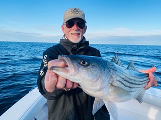 Photo of man holding a striped bass