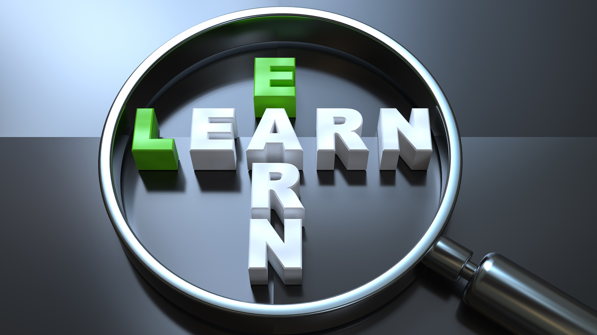 A magnifying glass on the words 'earn' and 'learn'
