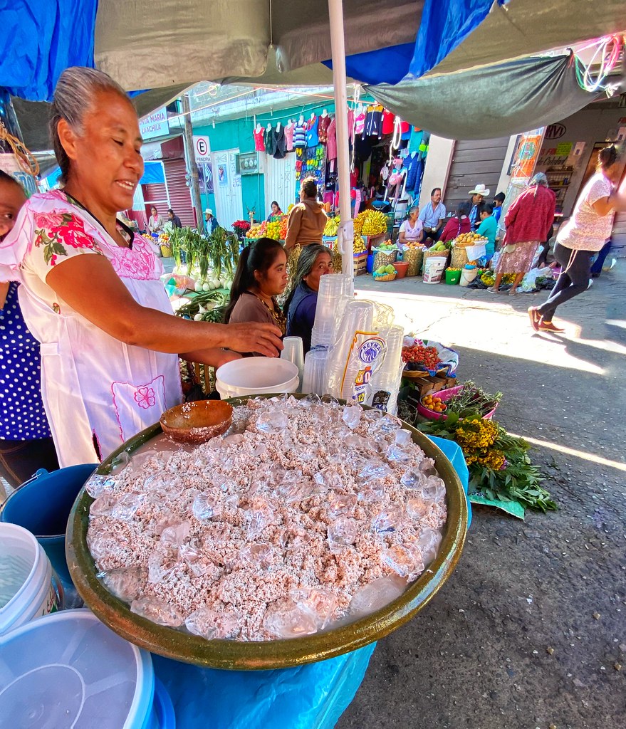 A lady in the market selling Tejate. - Tejate is a non-alcoholic maize and cacao beverage traditionally made in Oaxaca, Mexico, originating from pre-Hispanic times.