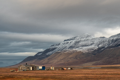 landscape nature spitsbergen svalbard arctic mountains snow clouds tundra building outdoors