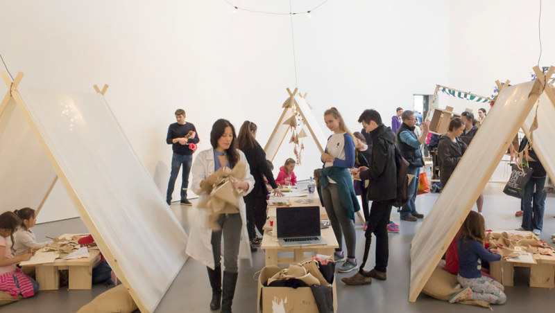 An interactive exhibition with tents, where children are doing craft activities 