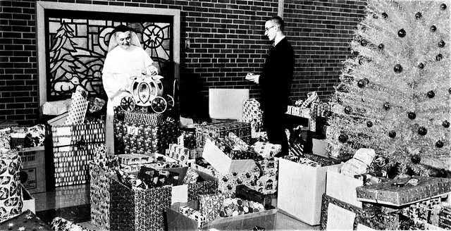 Dominican Sister with Christmas gifts for 31 needy families provided by students of Marian High School in 1964 Chicago Heights, Illinois