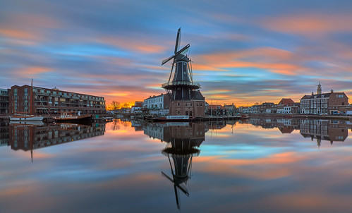 urban urbanphotography urbanlandscape city cityscape water stillwater waterscape waterfront river riverfront reflection windmill harbour ship boat church churchtower earlymorning cloudy sky clouds sunrise longexposure neutraldensityfilter breakthroughphotography x4nd10 manfrotto canon 7dmarkii efs1018mm netherlands haarlem spaarne adriaan bakenesserkerk