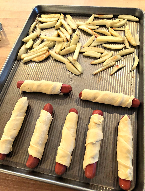 homemade pigs in a blanket and potato wedges