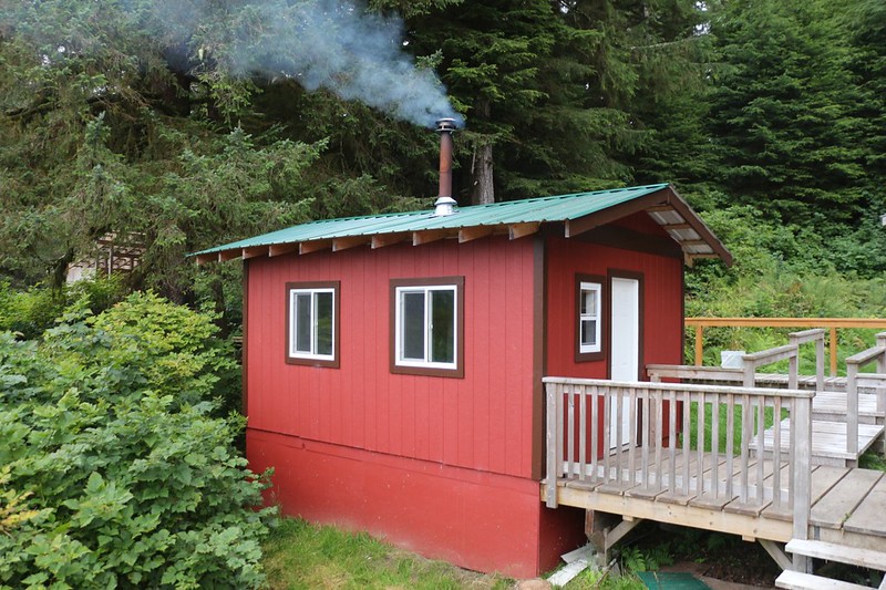 Our cabin at Nitinat Narrows with smoke coming out of the chimney pipe - it was nice and warm inside