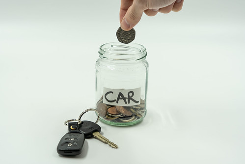 A jar of coins labelled "CAR"