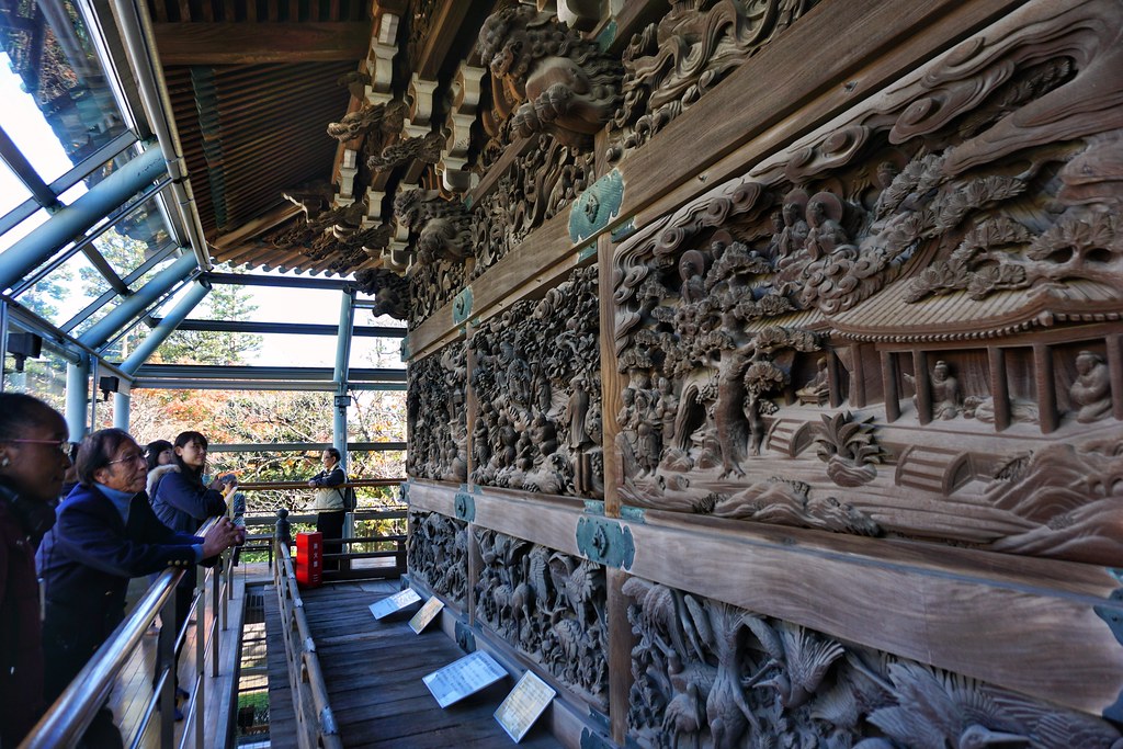 Tourists look at wooden carvings in Shibamata Taishakuten temple, Japan