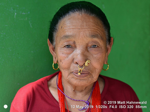 matthahnewaldphotography facingtheworld character head face eyes nose nosepiercing septumpiercing nosejewelry nosering nosestud gemstonejewelry earring livedinface wrinkles expression respect dignity humanity travel lifestyle grace beauty exotic ethnic tribal indigenous native local rural traditional cultural villager arkhetbazaar manaslutrek nepal asia asian nepali magar human person one female elderly old woman detail primelens nikkorafs85mmf18g 85mm street portrait closeup indoor naturallight colour posingcamera clarity happyplanet lookingatcamera sharpness fullfaceview headshot nikond610