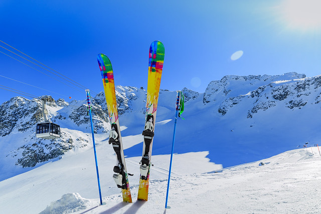 Ski winter season - mountains, cable car and ski equipments on ski run