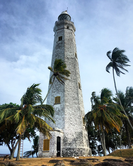 Dondra Head Lighthouse among the palm trees on the southernmost point in Sri Lanka, Devinuwara, Southern Province, Sri Lanka, March 2019