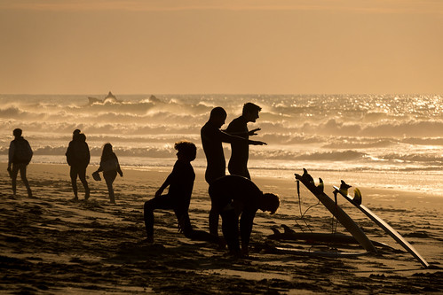 beach people surfers family sunset silhouette waves rocks sand praiagrande portugal canadapt
