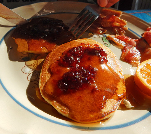 Pancakes, syrup and berry compote for a sun-lit breakfast in Zihuatanejo, Mexico