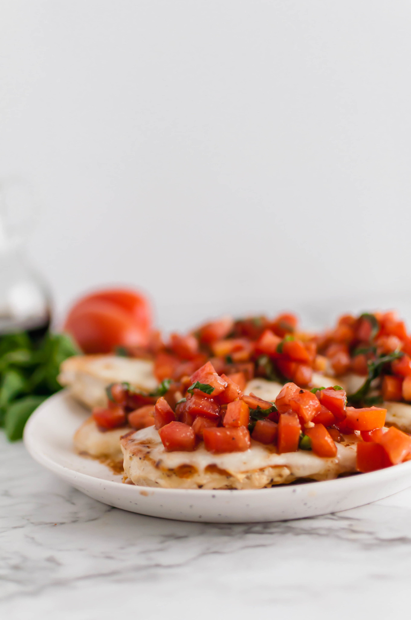 This Bruschetta Chicken comes together in less than 30 minutes for the perfect simple, healthy and fresh dinner. Perfectly seared chicken, lots of melted mozzarella and a super simple homemade bruschetta.