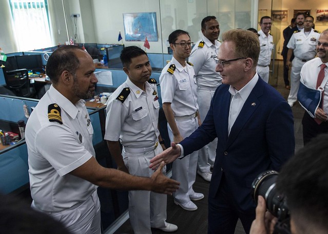 Acting Secretary of the Navy Thomas B. Modly meets with international liaison officers during a tour of the Information Fusion Centre.