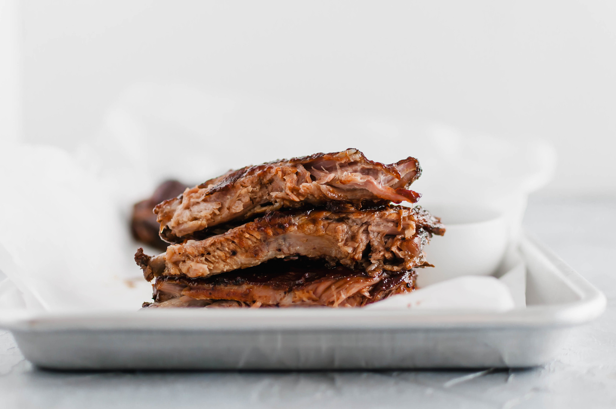 These Oven Baked Ribs are the ultimate in comfort. So simple and unbelievably tender. Rubbed with a delicious, rich coffee rub, baked then slathered in bbq sauce.