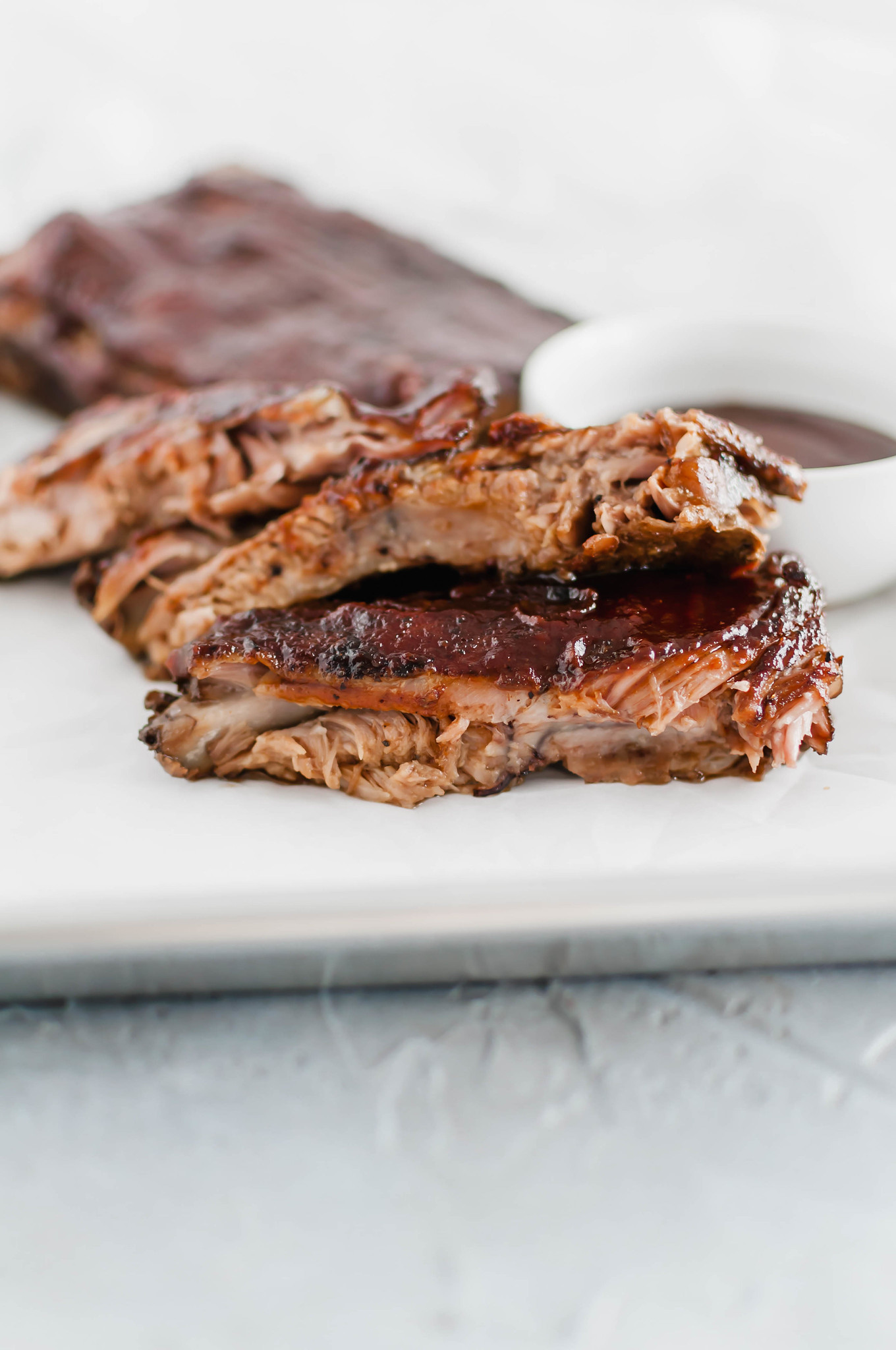 These Oven Baked Ribs are the ultimate in comfort. So simple and unbelievably tender. Rubbed with a delicious, rich coffee rub, baked then slathered in bbq sauce.