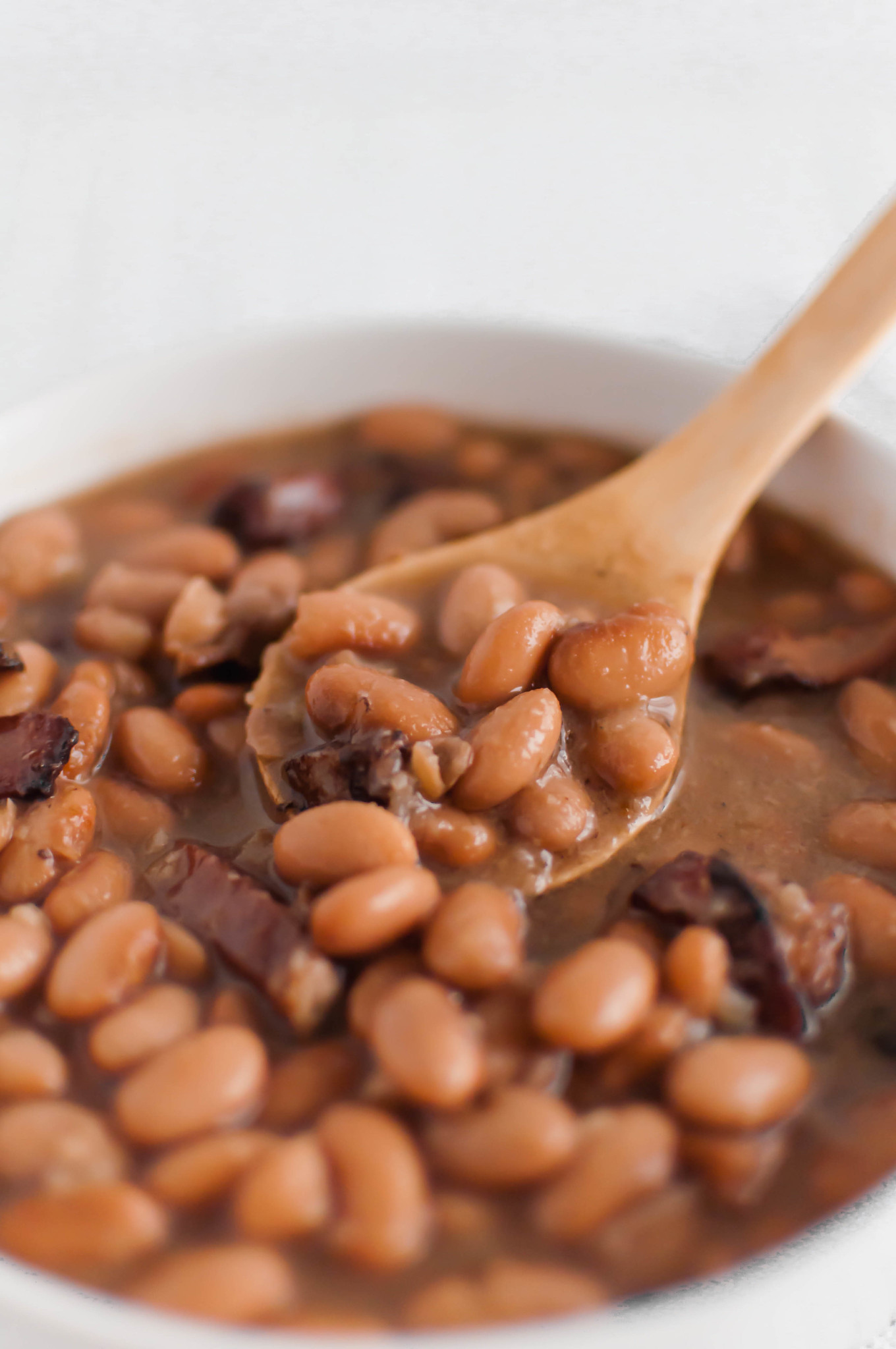 If you love Chipotle's pinto beans, look no further because now you can make them at home. Dried pinto beans cook all day in the slow cooker with bacon, onion and garlic to make these flavorful Bacon Pinto Beans. Perfect for rice bowls, nacho night or even on their own.