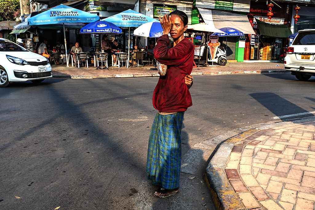 Thin woman looking unhappy on Rue Setthathirat--Vientiane