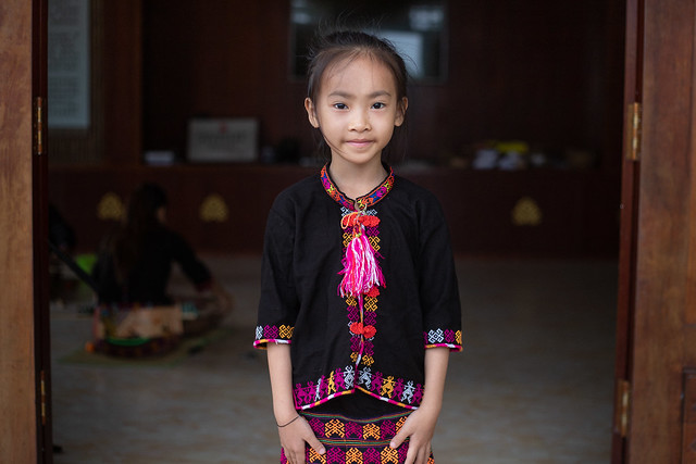 7 year old Miao girl poses for photo